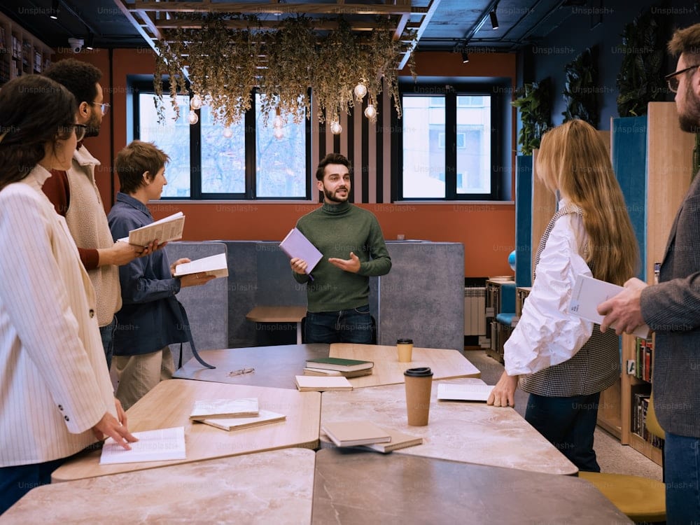 A group of people standing and talking around a table